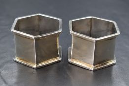 A pair of George V silver napkin rings, of plain hexagonal form, rubbed marks for Birmingham 1918,