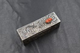 A white metal 800. grade lipstick holder, of rectangular form having scroll decoration with a