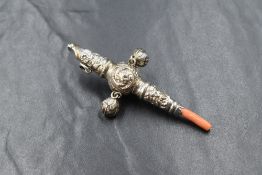 A Victorian silver baby's rattle, of traditional form having a whistle to the top, floral decoration