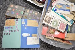 A quantity of mixed stamps and stamp albums, various mostly incomplete and housed in a large clear