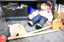 A Living Puppets 'Paula' 65cm hand puppet with carry bag and two wooden wheeled hobby horses.