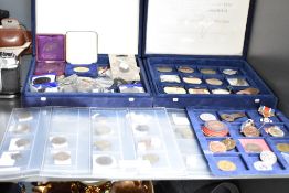 A collection of medals, tokens and badges together with some world coinage.