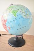A modern John Lewis plastic illuminated globe lamp upon a stand, marked to base, 40cm, condition