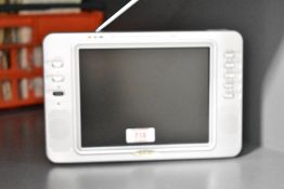 A vintage portable LCD television with antenna, accompanied by a canvas travel bag, 25cm x 17cm,