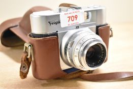 A Voigtlander Vito B camera with Color-Skopar 1:3,5 50mm lens in leather cover. Slight dent just