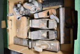 An assortment of items including five vintage wooden wood planes, two metal blowtorches, a brass