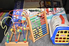 A collection of children's toys including a Selecta Spielzeug Casa Rustica playhouse, a wooden