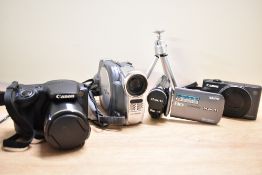 Three digital cameras, and DVD cam. A Canon Powershot SX420IS in soft camera bag, A Canon SX620HS in
