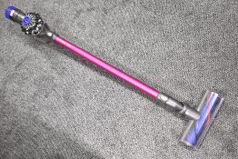 A Dyson v6 absolute cordless vacuum cleaner with angle brush accessory. No charger so will need a