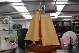 A vintage wooden model sail boat table lamp, having hand sewn fabric sails, unmarked, 71cm in