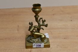 A Victorian cast brass deer candlestick, modelled as a kneeling doe before a tree, the trunk