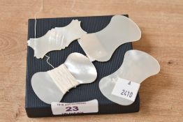 Four Victorian mother-of-pearl thread winders, with one to feature a scalloped design, unmarked,