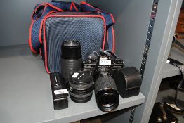 A Praktica B100 Electronic camera with Prakticar PB 1:4,5-5,6 80-200mm lens, a Praktica Auto Zoom