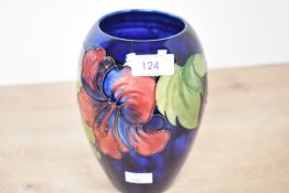 A 20th-century Moorcroft Pottery 'Hibiscus' vase, featuring tube-lined floral decoration upon a deep