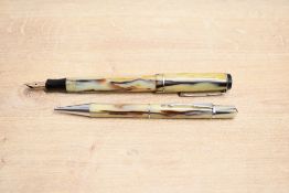A Platignum button fill fountain pen and pencil set in Pearl, Black and red