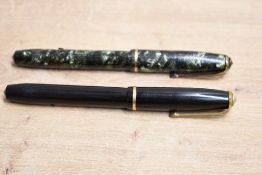 Two Conway Stewart 28 lever fill fountain pen one in green hatched the other black with single cap