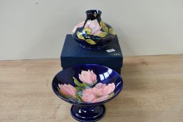 Two 20th-century Moorcroft Pottery 'Pink Magonolia' pieces, to include a pedestal bowl and bud vase,