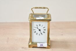 A late 19th to early 20th-century French brass 5 glass carriage clock, featuring glass panels and