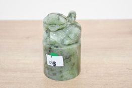 A 20th-century Chinese carved green-stone seal 'chop' stamp, featuring an intricately carved foo-dog