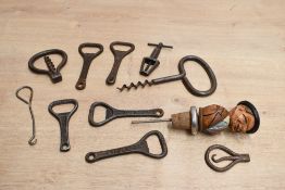 A selection of late 19th to early 20th-century metal and corkscrews and bottle openers, to feature a