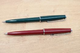 Two Parker 45 ballpoint pens one in green the other burgundy