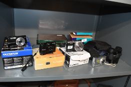 Four Digital cameras and pair of Binoculars. A boxed Olympus U750, a boxed Canon Powershot A1300,