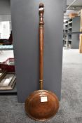 A 19th-century copper bed warming pan, having a smooth turned wood handle, unmarked, approximately