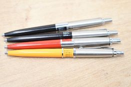 Four Parker Jotter ballpoint pens with perpetual calendars. In yellow, red and two black. one