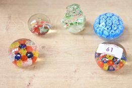 A selection of small 20th-century decorative millefiori glass paperweights, to include four orb-