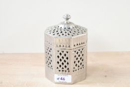 An Eastern white metal Betel nut holder, of octagonal form having a moulded finial top with