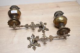Two late 19th to early 20th-century brass Loki 'Number 3' wall-mounted oil lamp, featuring a
