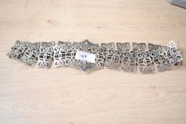 A silver plated nurses belt the large central buckle of a pierced scroll design flanked by further
