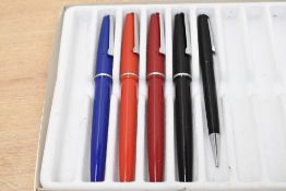 Four Platignum Silverline aero fill fountain pens and a pencil. In Blue, Red, Orange and Black
