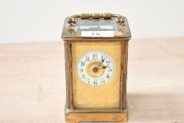 A small 20th-century R.H.Saxton brass 5 glass carriage clock, having floral gilt decoration around a