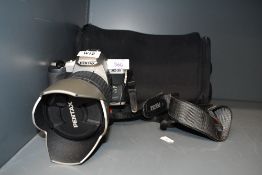 A Pentax MZ30 camera with SMC Pentax FA 1:3,8-5,6 28-200mm lens in soft camera bag