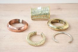 A quantity of 20th century African brass, metal and copper cuff bracelets, to include a twisted