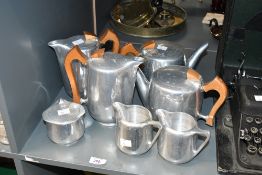 A mid 20th-century Picquot aluminium tea and coffee set, featuring teak wood handless and a stylised