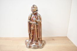 A 20th-century Art Deco-style lustreware metal fire tool set, designed in the form of a knight,