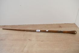 A small late 19th to early 20th-century Folk Art-style wooden walking stick, having a hand carved