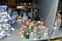 A large selection of 19th to early 20th-century pharmaceutical and apothecary glass bottles, to