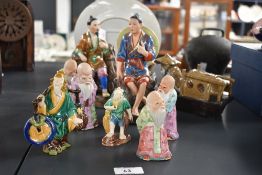A small selection of vintage Chinese pottery figurines, to include a set of Fu Lu Shou statues, some