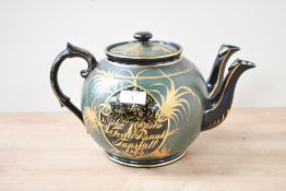 An unusual Victorian Aesthetic Movement Jackfield-style double spouted teapot, featuring a black and