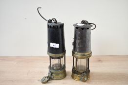 Two presumed 19th-century brass and iron safety lamps, with one example featuring a brass lock,