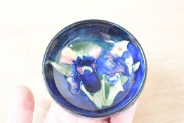 A small 20th-century Moorcroft pottery 'Orchid' pin dish, having a colourful tube-lined orchid