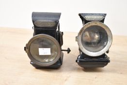 Two late 19th-century metal Joseph Lucas 'King of the Road' bicycle lamps, featuring glass