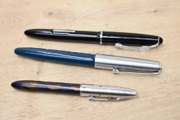Three Platignum lever fill fountain pens, A Petite in Brown and Black marble, a Varsity in Teal