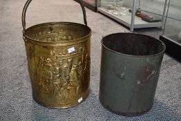 A vintage embossed brass coal bin, of cylindrical form with over handle, galvanised liner and