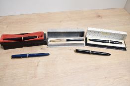 Five Parker fountain pens. Three parker Duofolds one boxed two black and one blue, a boxed Parker