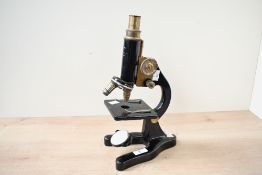 An early 20th-century Flatters and Garnet Limited of Manchester metal monocular microscope, having