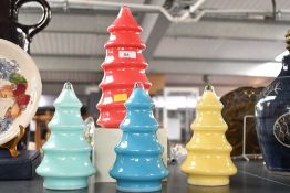 Four colourful contemporary decorative glass Christmas trees, each fitted with plastic bases so they